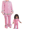 Pink and white striped pajama set with matching doll outfit on a white background
