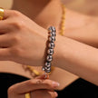 Silver-tone round beaded bracelet with a small heart charm, lobster clasp, and adjustable extension chain.