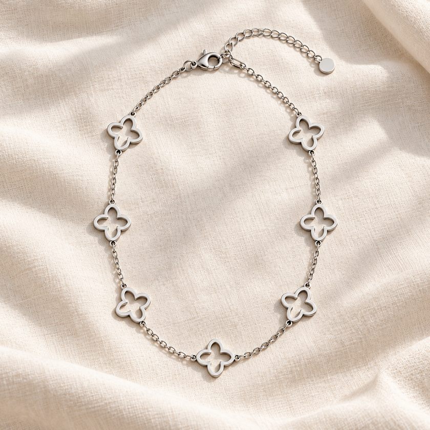 Open Clover Silver: Silver-tone stainless steel necklace with open quatrefoil stations and a 5 cm extender.