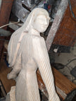 Carved wooden figure in a workshop setting