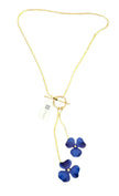 Gold necklace with blue flower pendants on a white background