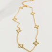 Open Clover Gold: Gold-tone stainless steel necklace with open clover stations and a 5 cm extender.