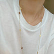 Long Oval Gold: Long gold-plated stainless steel station necklace with open oval details, measuring 120 cm.