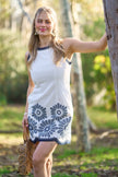 women’s white coastal vacation dress with navy embroidery and scalloped hem