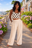 women black beige crochet crop top paired with wide leg pants resort outfit