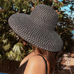 women black sun hat oversized brim beachwear resort style side view
