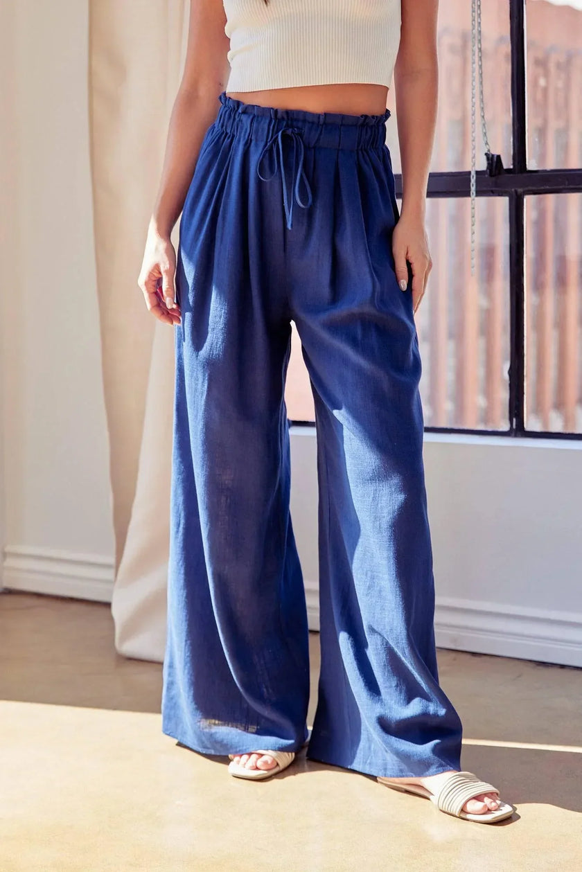 women navy linen palazzo vacation pants styled for tropical resort setting