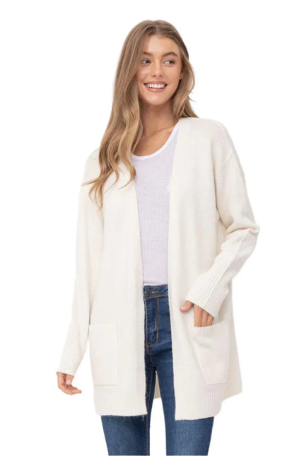 women cream midi open front cardigan layered over blue ribbed tank with black joggers coastal outfit